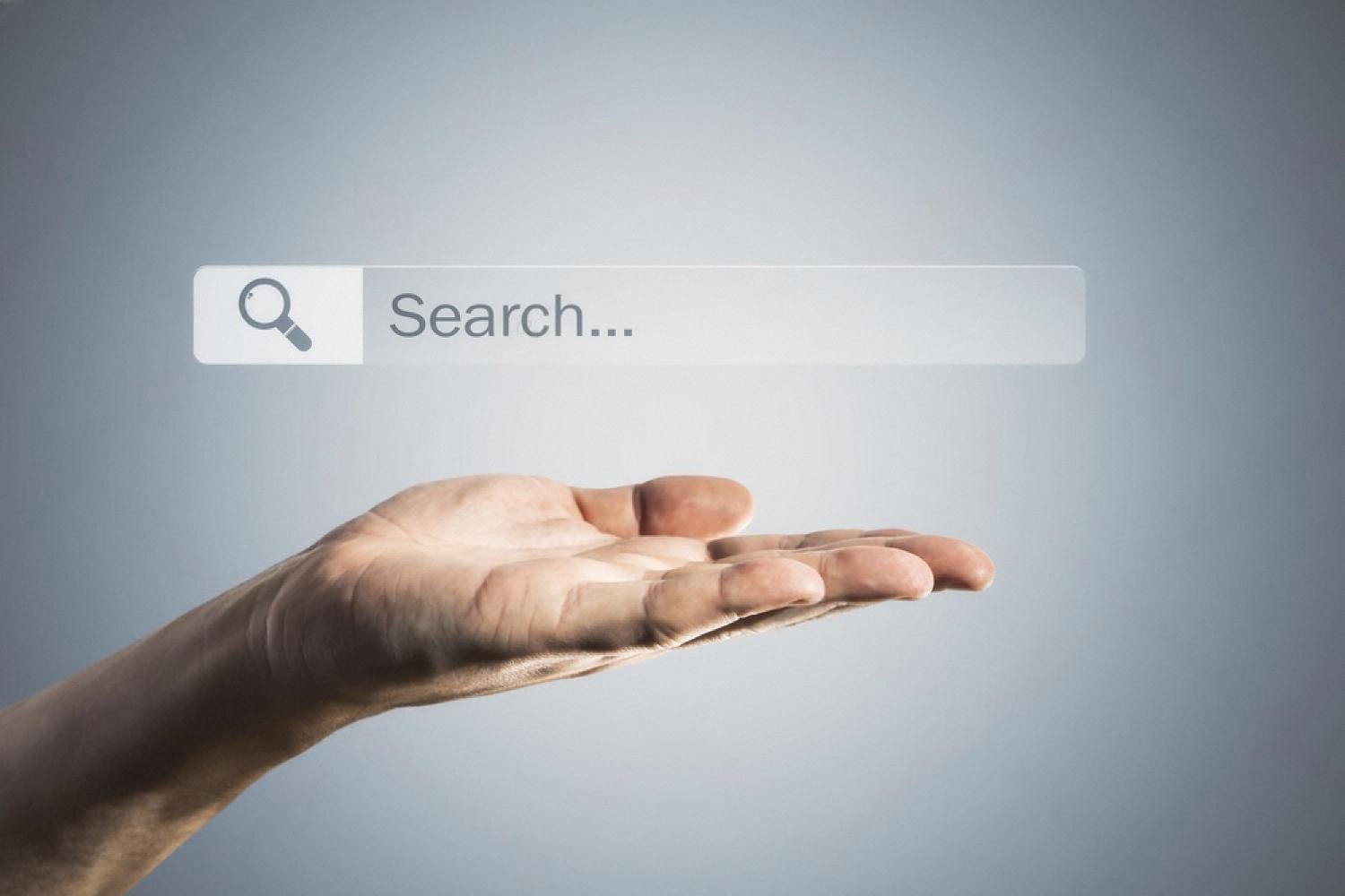 Hand reaching towards a floating search bar used to check domain name availability