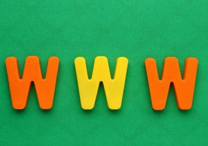 Colourful WWW letters on a green background representing web domain extensions